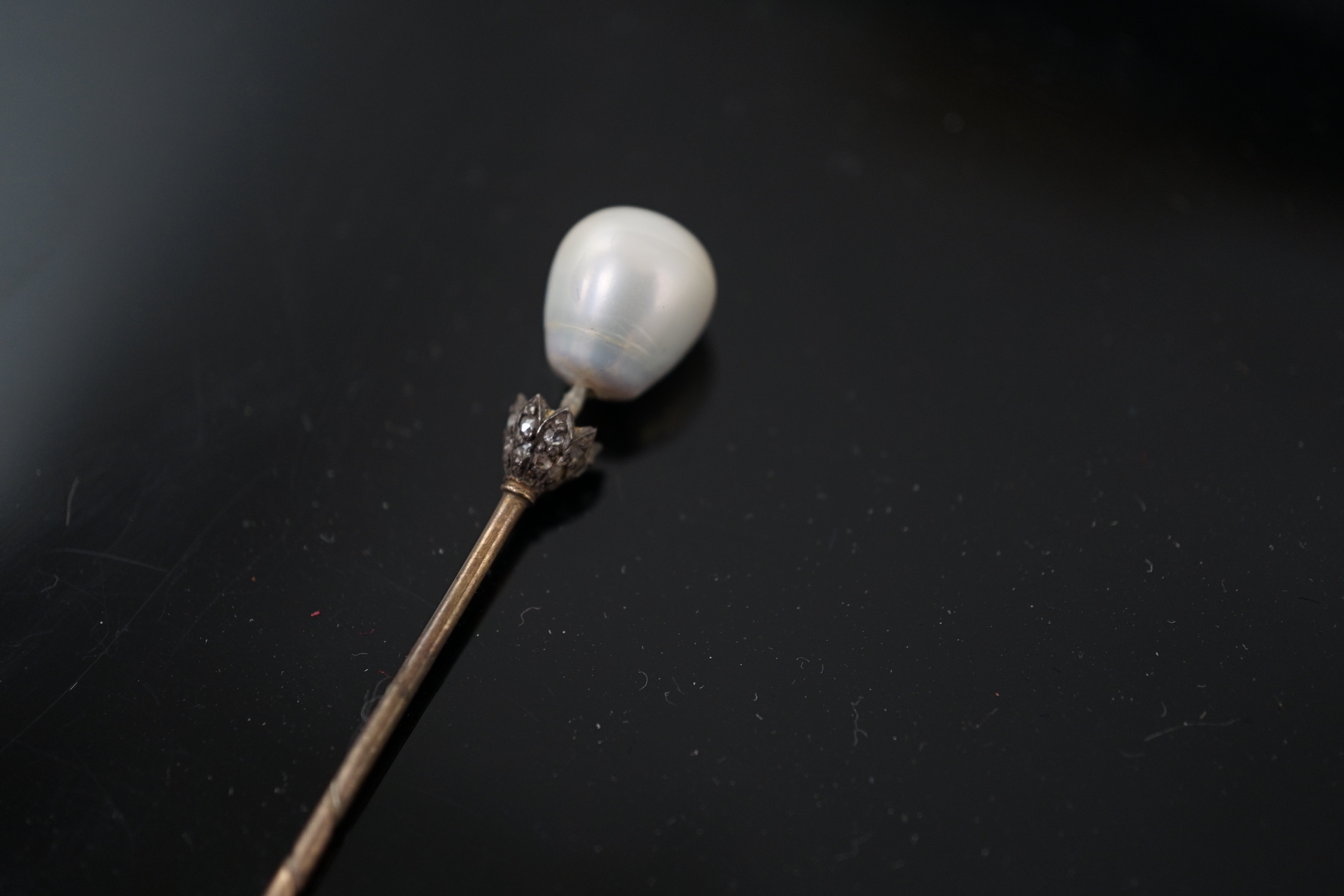 A Victorian gold, single stone part drilled natural saltwater pearl and rose cut diamond chip set stick pin